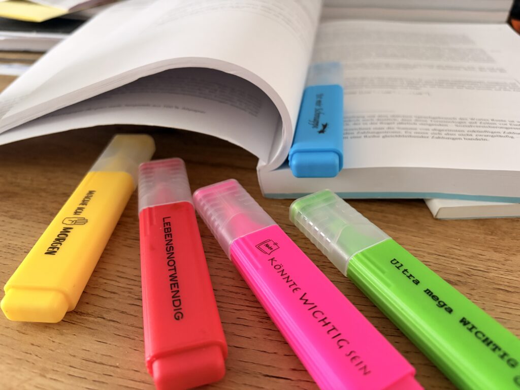 Studienbriefe mit Textmarkern im Vordergrund